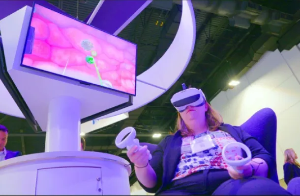 Photo of a woman wearing goggles to participate in a virtual reality activation.