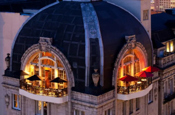 Rooftop balcony of The Bellevue Hotel at night.