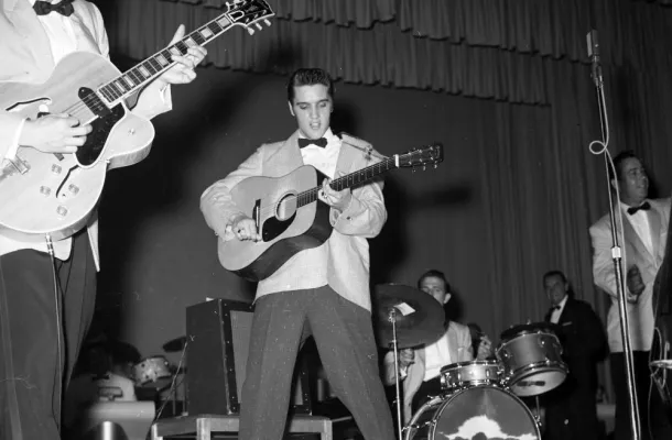 Elvis Presley performing on stage in the 1950s.