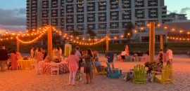 Event setup on the beach with twinkle lights in front of Fort Lauderdale Marriott Harbor Beach Resort & Spa 
