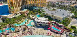 Aerial photo of Mandalay Bay Resort and Casino with the words "welcome back" in the sand on its beach.