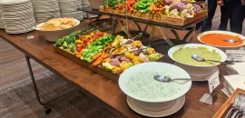 Photo of a serving table with a large selection of vegetables and dips.