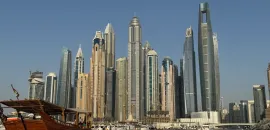 Photo of the skyline of Dubai from a boat on the water.