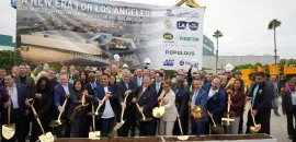officials hold shovels at groundbreaking ceremony