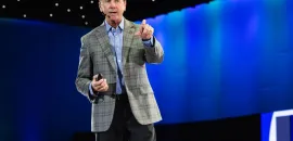 Photo of Steve O'Malley on stage, pointing at the audience.