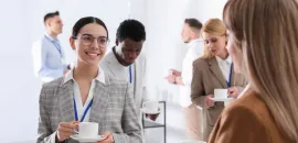 young businesspeople talking while drinking coffee