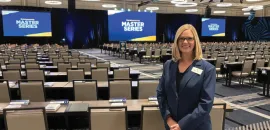 planner standing in back of ballroom