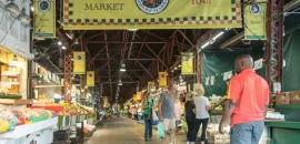 Photo of a man walking through the Soulard District in St. Louis.