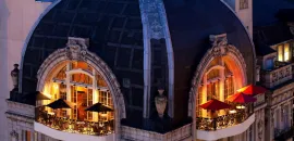 Rooftop balcony of The Bellevue Hotel at night.