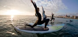 People doing stand-up yoga on paddleboards.