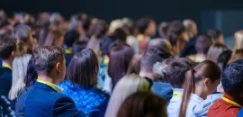 Image of a crowd of people at a meeting.