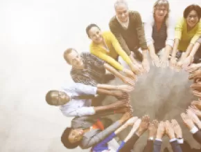 Group of people standing in a circle