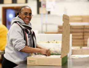 A Program Participant from Women’s Bean Project Makes Snacks and Baking Mixes for Gift Assortments. CREDIT: Lauri Pastrone.