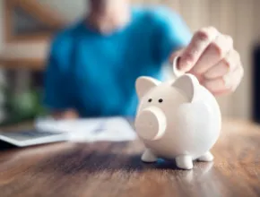 Saving money into a piggy bank