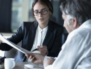A man and woman reviewing a contract.