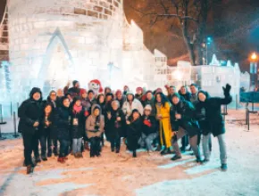 The group poses for a photo with Bonhomme outside his ice castle