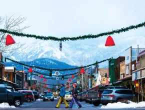 Photo of Whitefish, Montana in wintertime with skiers crossing a street.