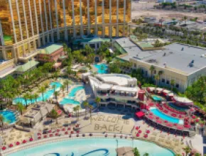 Aerial photo of Mandalay Bay Resort and Casino with the words "welcome back" in the sand on its beach.