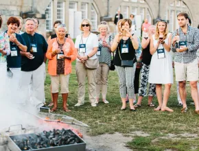 Group of attendees watching a clam bake at Fort Adams in Newport, Rhode Island