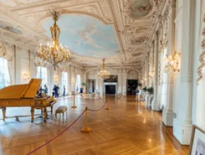 Photo of Newport, Rhode Island's Rosecliff Mansion with grand piano in the foreground.