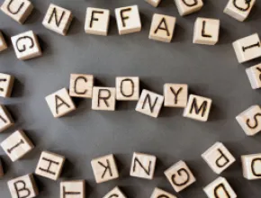 A photo of blocks in an array that spells out "acronyms"