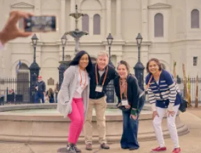 Group of meeting attendees pose for a photo in New Orleans