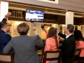 Colleagues watching a game together at the Sonoma Lobby Bar at DoubleTree by Hilton At SeaWorld in Orlando