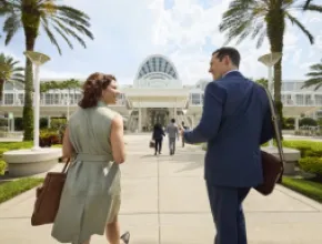 Two attendees walking into the Orange County Convention Center in Orlando