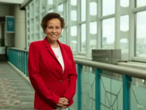 Photo of Sandi Harvey standing in a red jacket in the Atlantic City Convention Center.