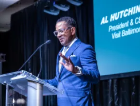 Photo of Al Hutchinson speaking on stage.