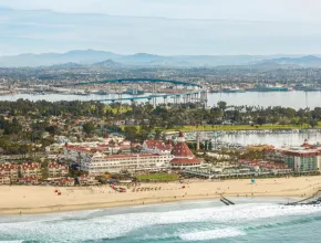 Aerial photo of Coronado island, with a beach and the Del Coronado in the foreground.