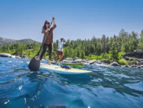 Couple paddleboarding on Lake Tahoe. 