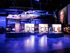 Photo of two suspended military helicopters in an exhibit space at the Sullenberger Aviation Museum.