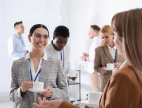 young businesspeople talking while drinking coffee