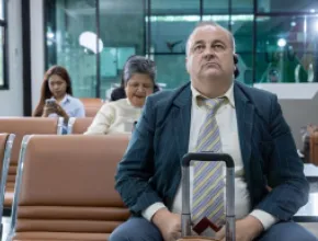 man sitting at airport