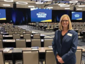 planner standing in back of ballroom