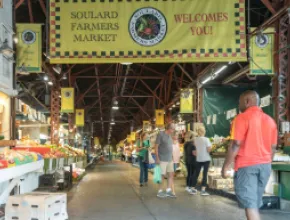 Photo of a man walking through the Soulard District in St. Louis.