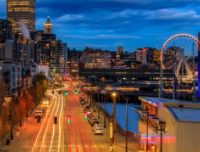 Image of the Seattle waterfront at night.