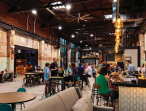 Armature Works food hall, with people sitting at a counter.