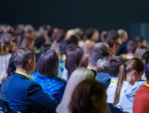 Image of a crowd of people at a meeting.