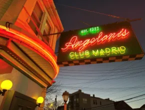 Angelino's Club Madrid exterior with neon sign.