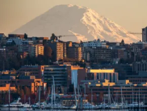 Skyline of Seattle from the waterfront, with Mt. Rainier in the background.