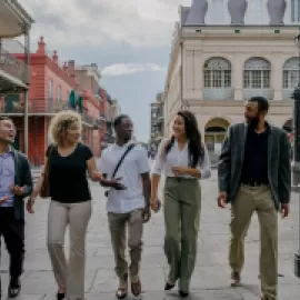 Group of attendees walking down a street in New Orleans