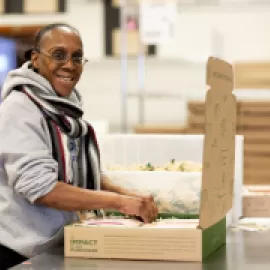 A Program Participant from Women’s Bean Project Makes Snacks and Baking Mixes for Gift Assortments. CREDIT: Lauri Pastrone.