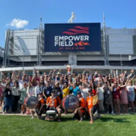 Group shot at Meetings Today LIVE! outside of Empower Field in Denver