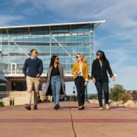 four people walking along Dubuque, Iowa's riverwalk