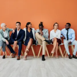 Group of people sitting in a row.