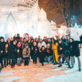 The group poses for a photo with Bonhomme outside his ice castle