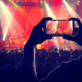 Someone recording a concert with a phone.