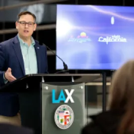 Photo of Adam Burke speaking at Visit California event.